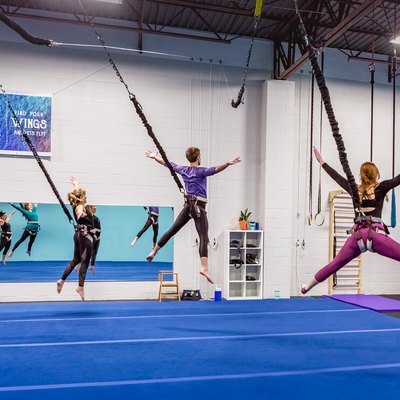 group of people in a gymnasium doing a bungee workout