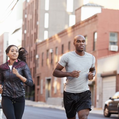 Young couple jogging in Brooklyn street, close up