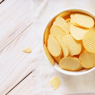 crispy potato chips in a white bowl