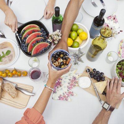 Hands reaching for plant based diet foods