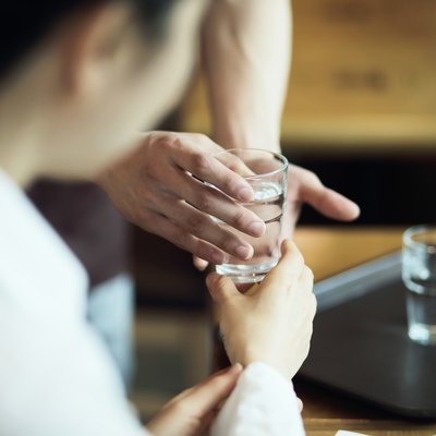 waiter serving a cup of water