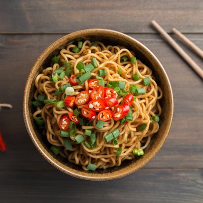 Top view of a bowl of spicy ramen noodles with pepper