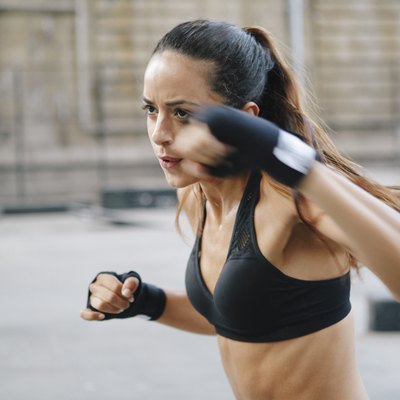 Young woman boxing in urban setting