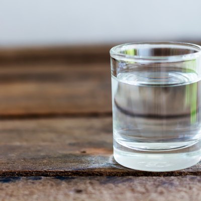 Close-Up Of Water In Drinking Glass On Wooden Table