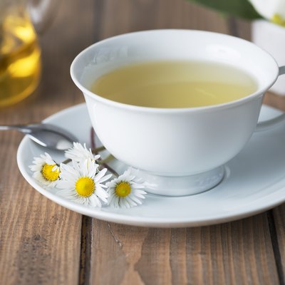 Herbal tea in a white cup with a saucer.