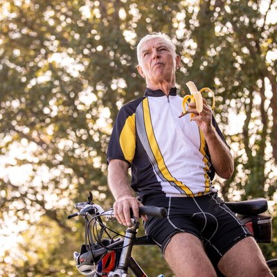 Senior Cross-country Cyclist Eating a Banana