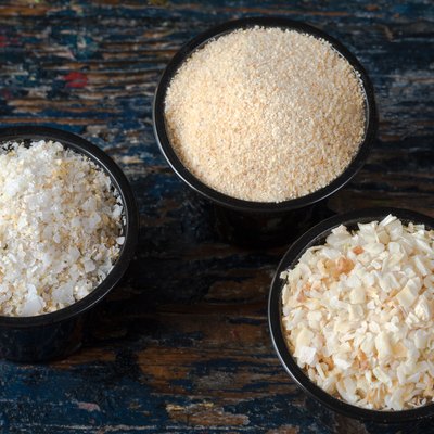 High Angle View Of Minced Onion With Garlic Salt And Powder In Bowls On Wooden Table