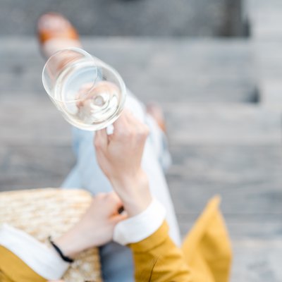 Overhead view of a woman with a glass of white wine