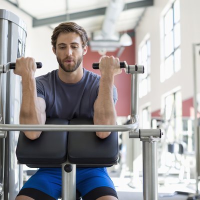 Active young man exercising in a gym