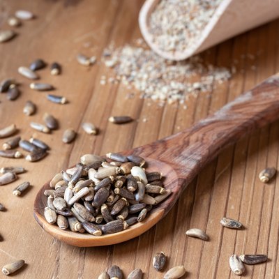 Milk thistle seeds on a wooden spoon