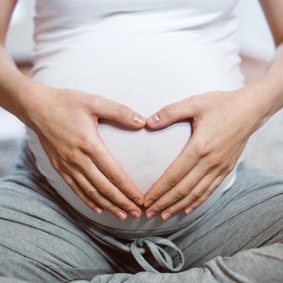Pregnant women with hands on stomach