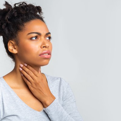 Upset woman having pain in her throat