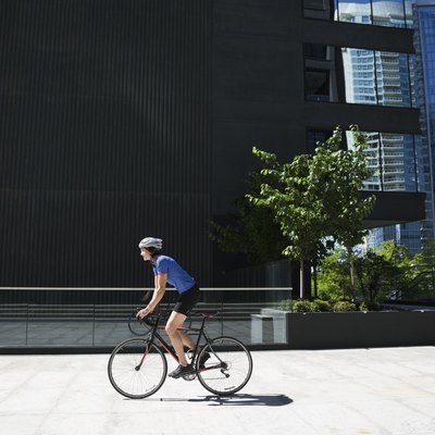 Woman riding bicycle in sunny city
