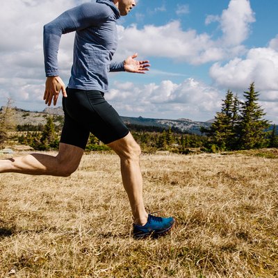 Man trail running wearing compression shorts