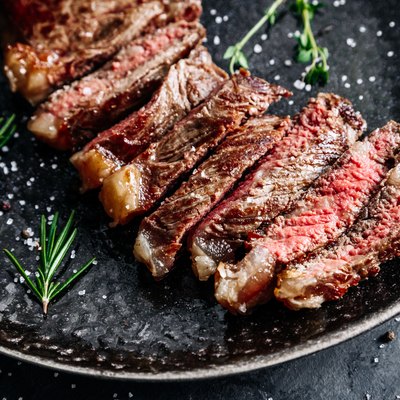 New York sirloin beef steak medium rare with rosemary top view