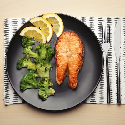 Low-carb roasted salmon steak with broccoli on plate for keto diet