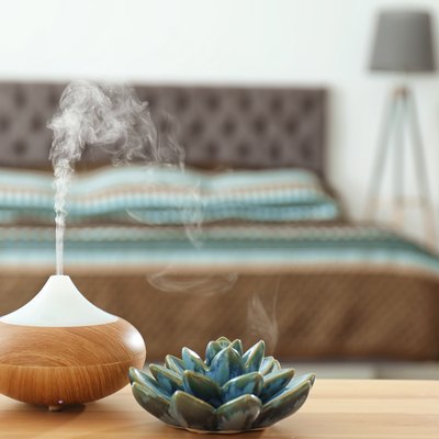 Aroma oil diffuser on table at home. Air freshener