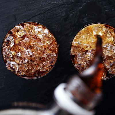 cola soda pop being poured into glass flat lay composition