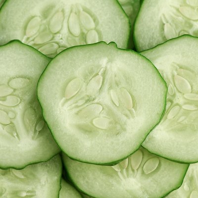 Fresh slice cucumber close-up background.