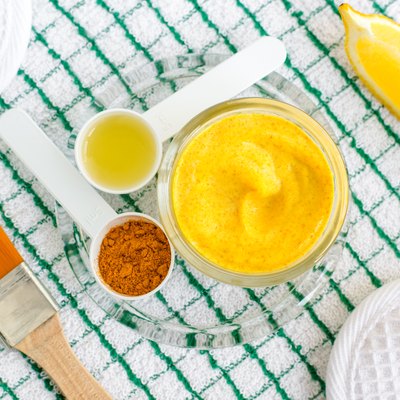 Turmeric and greek yogurt (sour cream or kefir) facial mask with lemon and olive oil. Ingredients for preparing diy face and hair masks and moisturizers. Homemade beauty treatments recipe. Top view.