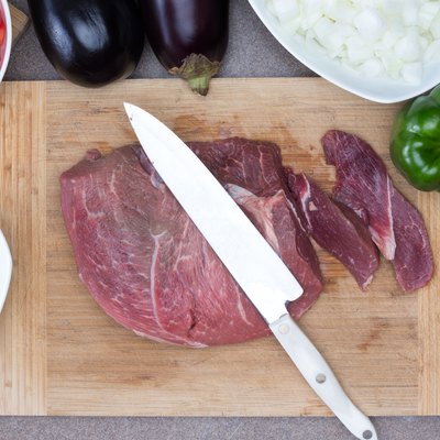 Meat on Chopping Board with Ingredients on Sides