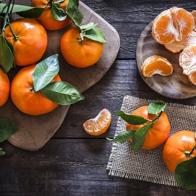 Fresh organic mandarins on rustic wooden table