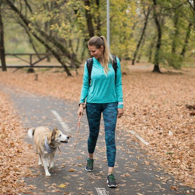 Woman walking with dog in park
