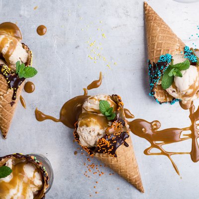 Ice cream with caramel sauce in waffle cone