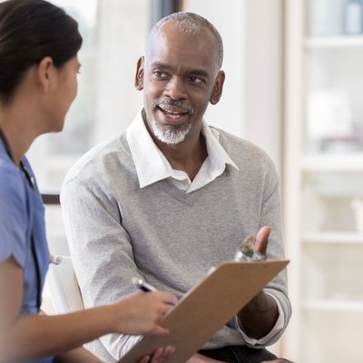 Senior man discusses diagnosis with doctor