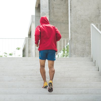 Urban athlete running upstairs. Sporty man working out outside and climbing stairs.