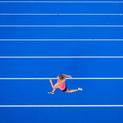 Top view of female runner on tartan track