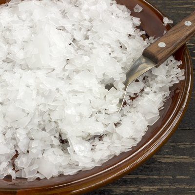 Magnesium chloride flakes in a saucer