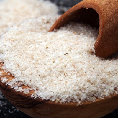 Portion of Psyllium Seeds on rustic dark background. Psyllium seed husks