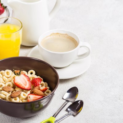 Whole grain rings cheerios, coffee, orange juice and egg. Balanced traditional breakfast