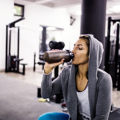 Bodybuilder girl relax after exhausting training