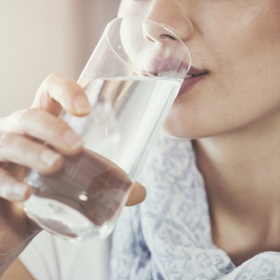 Young woman drinking pure glass of water