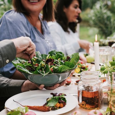 Friends enjoying a dinner together in greenhouse harvest party