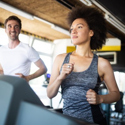 Fit people running in machine treadmill at fitness gym