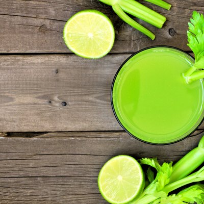 Celery juice, top view over rustic wood with copy space