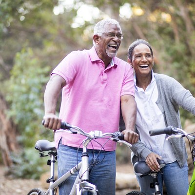 Senior African American Couple Riding Bikes to prevent diabetes with exercise
