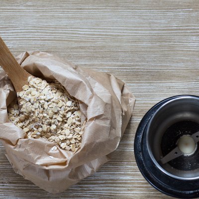 Top view of oats and coffee grinder for making oat flour
