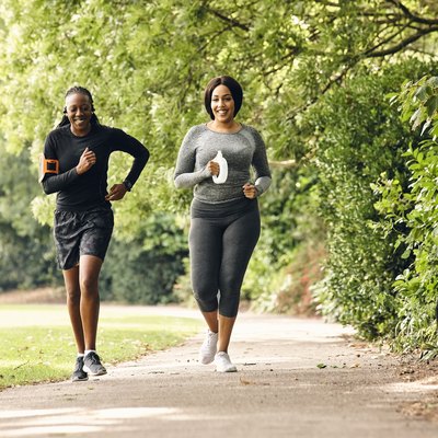 two women running in the park for partner workout