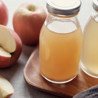 Apple cider vinegar with mother in glass bottles, probiotics food for gut health