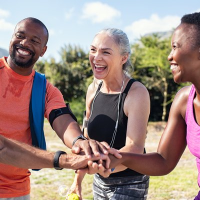 Mature people stacking hands after workout