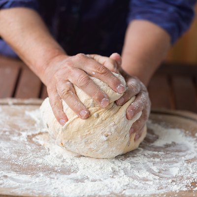 Hands kneading dough for bread