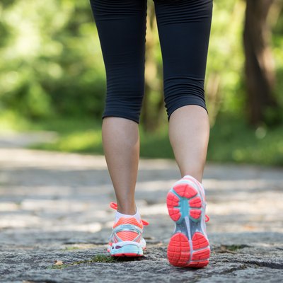 young fitness woman hiker legs at forest trail
