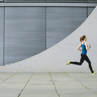Woman running in front of a building