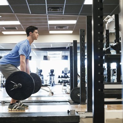 Man doing deadlifts in a gym