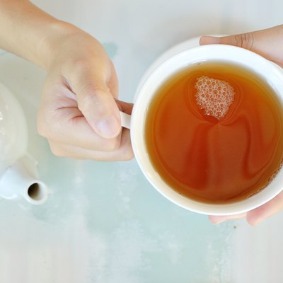 Hands of a woman with a cup of tea