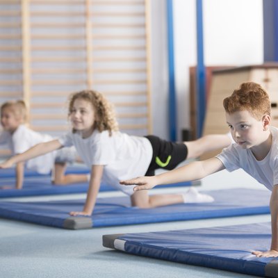 Kids exercising balancing yoga pose